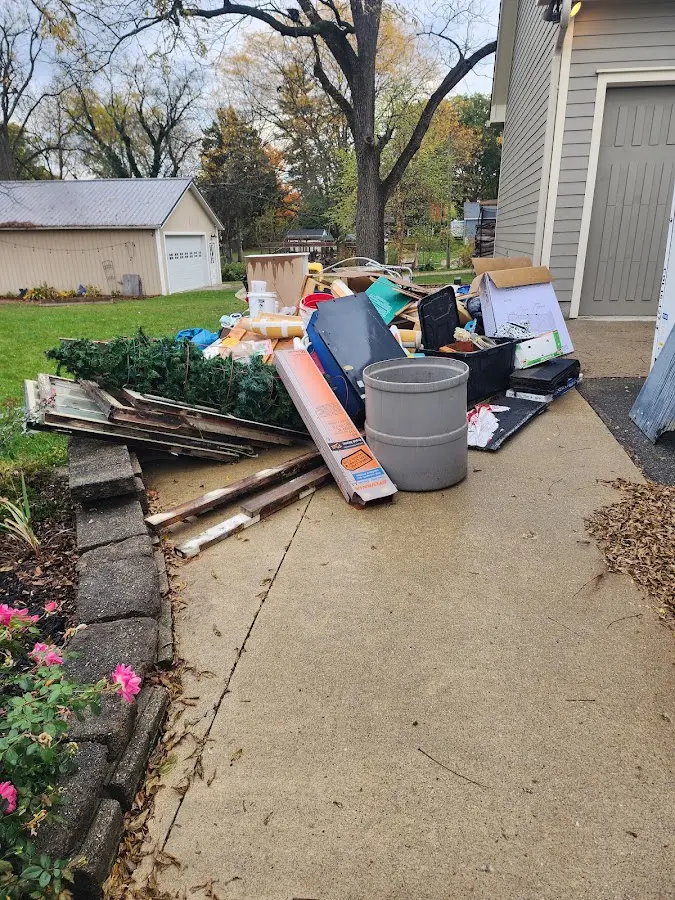 Dumpster being loaded with debris for 30 Yard Dumpster Rental in La Follette